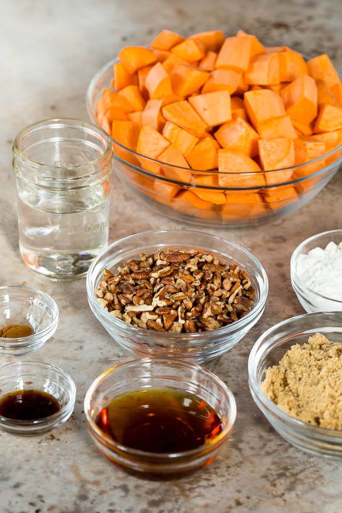 Bowls of sweet potatoes, brown sugar, spices and pecans.