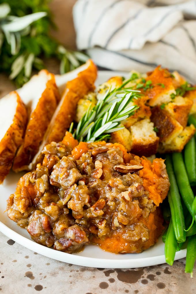 A plate of crock pot sweet potato casserole served with turkey and stuffing.