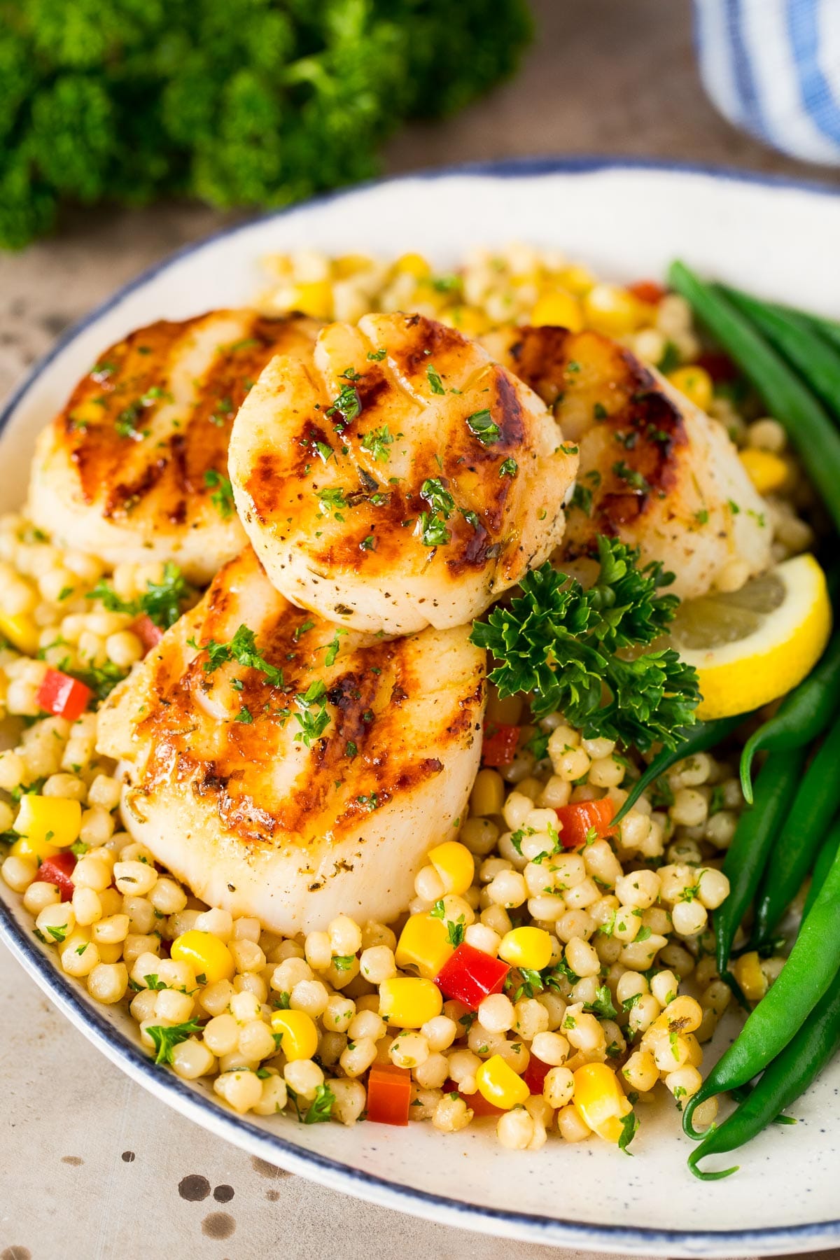 Grilled scallops served with couscous and green beans.