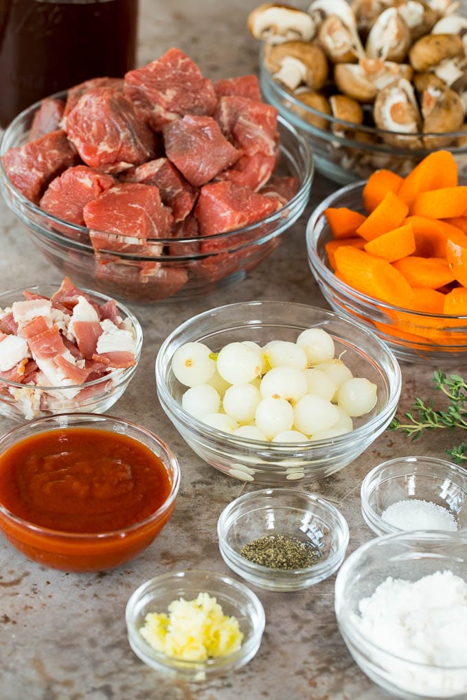 Bowls of beef, vegetables and seasonings.