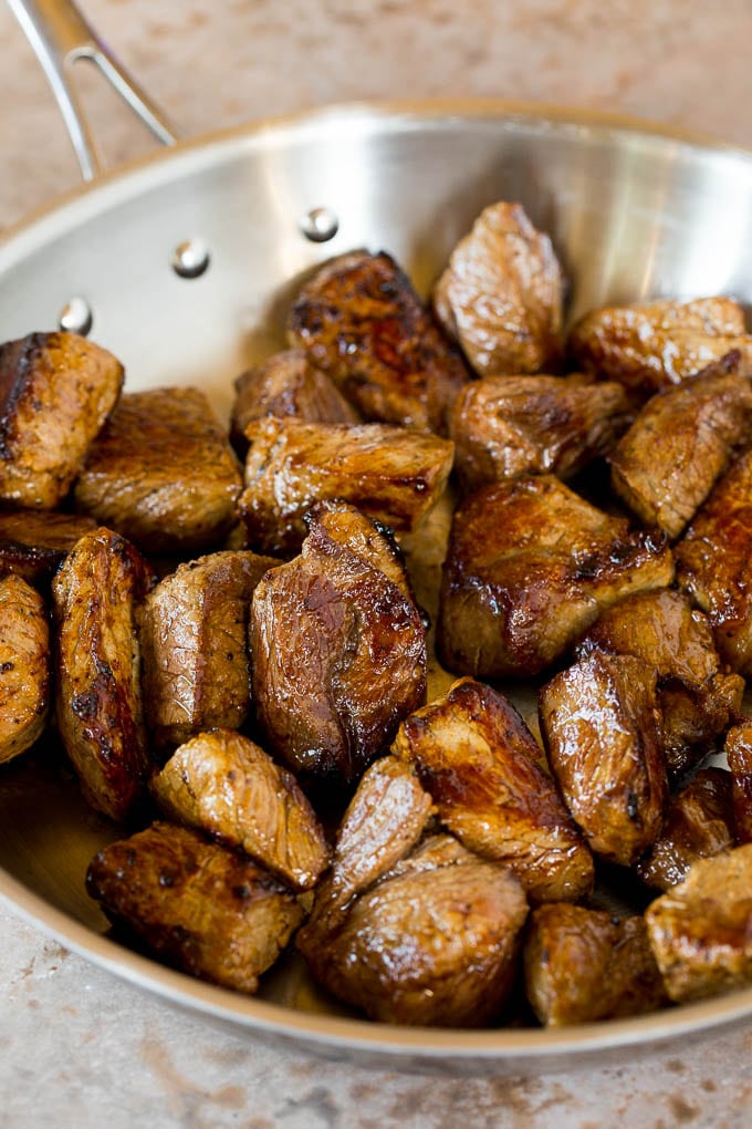 Browned beef cubes in a skillet.