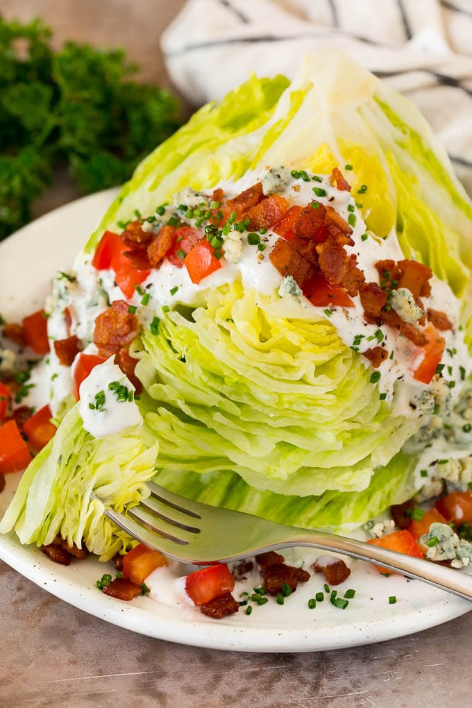 A fork that has cut into a wedge salad.