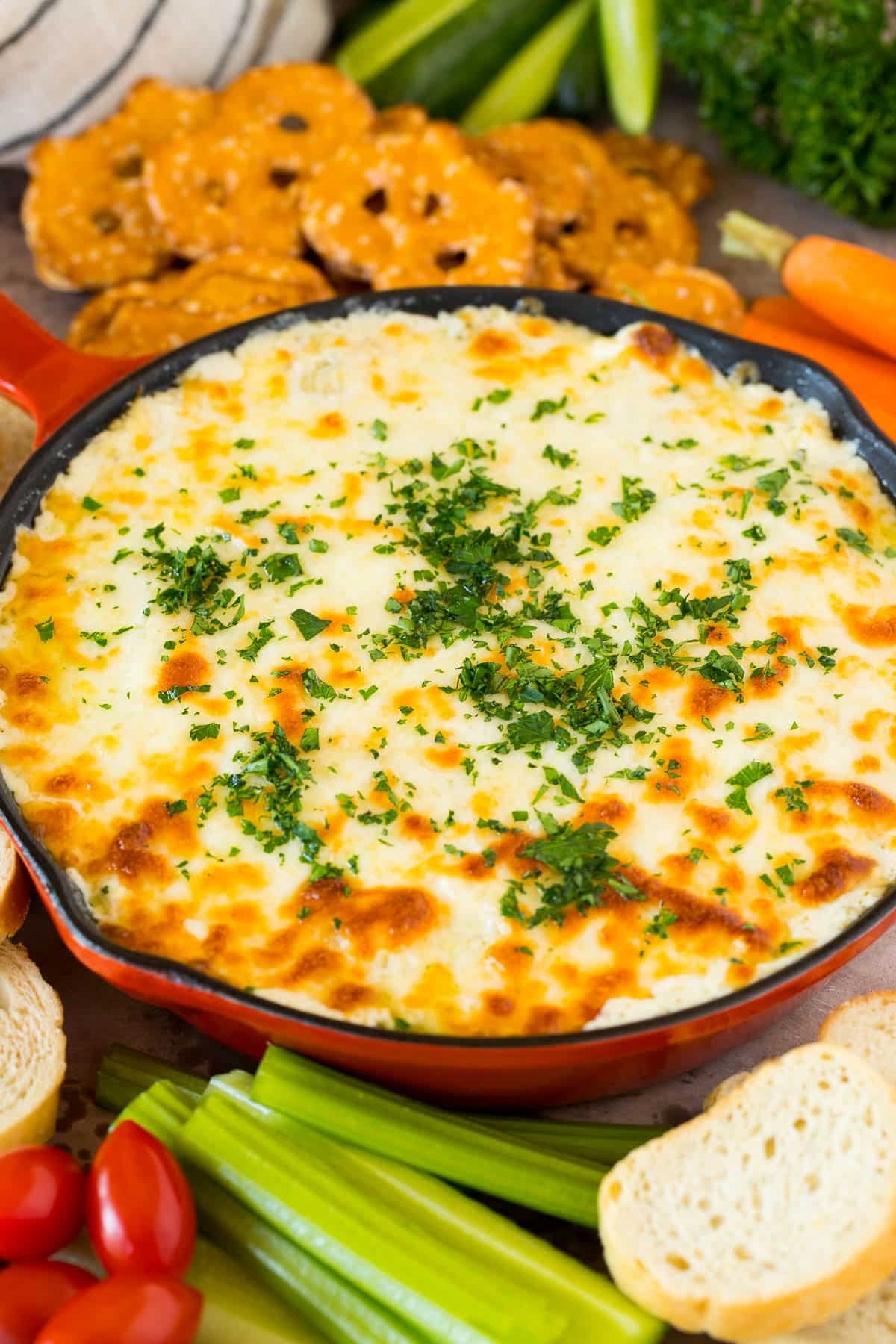 A pan of creamy dip with cheese melted on top.