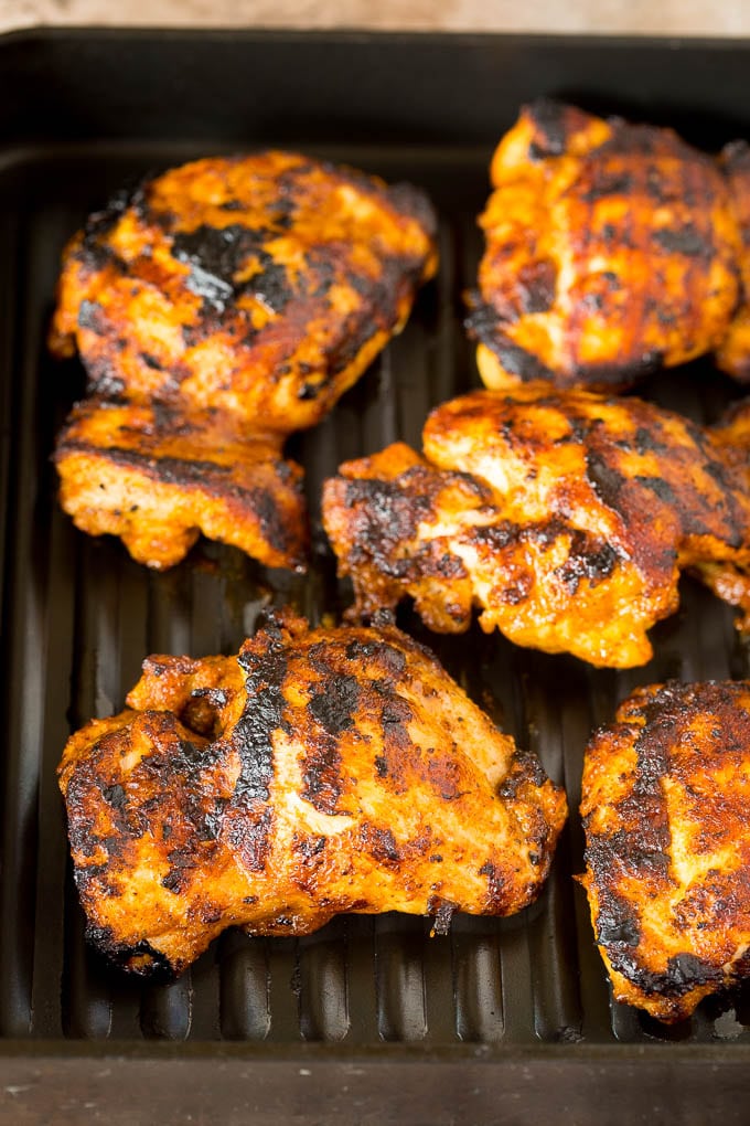 Chicken thighs cooked on a grill pan.