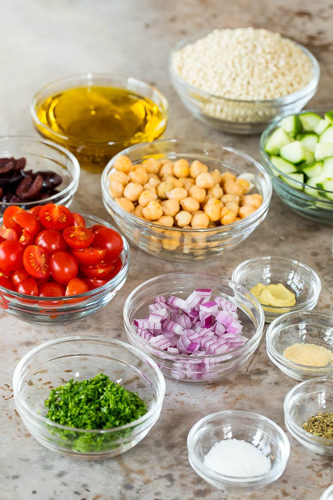 Bowls of vegetables, chickpeas, couscous and herbs.