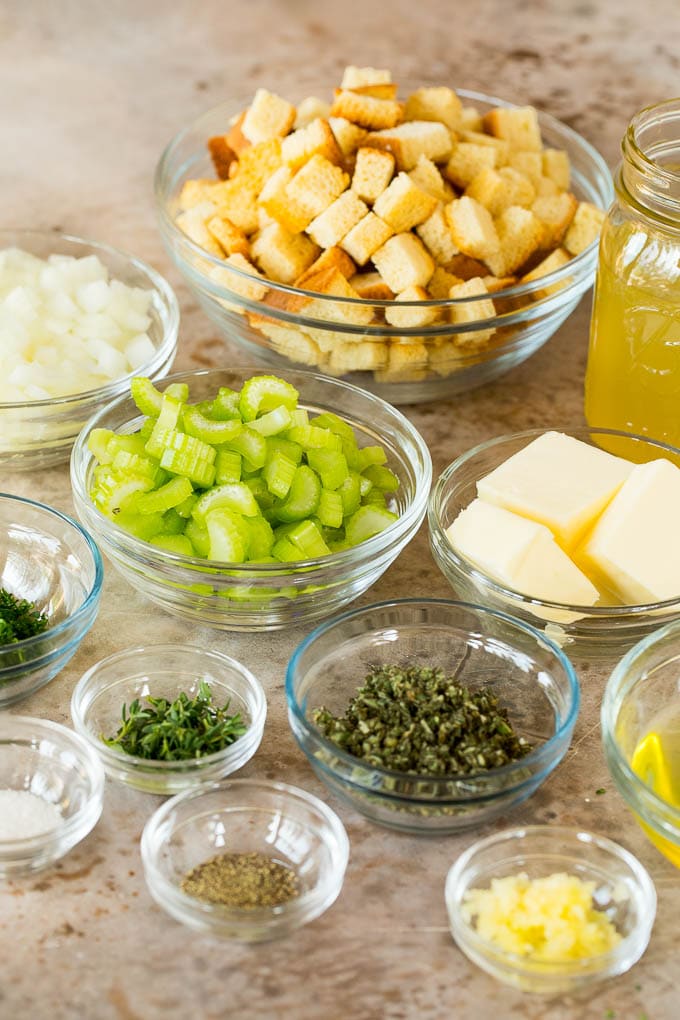 Bowls of bread cubes, vegetables, herbs and seasonings.