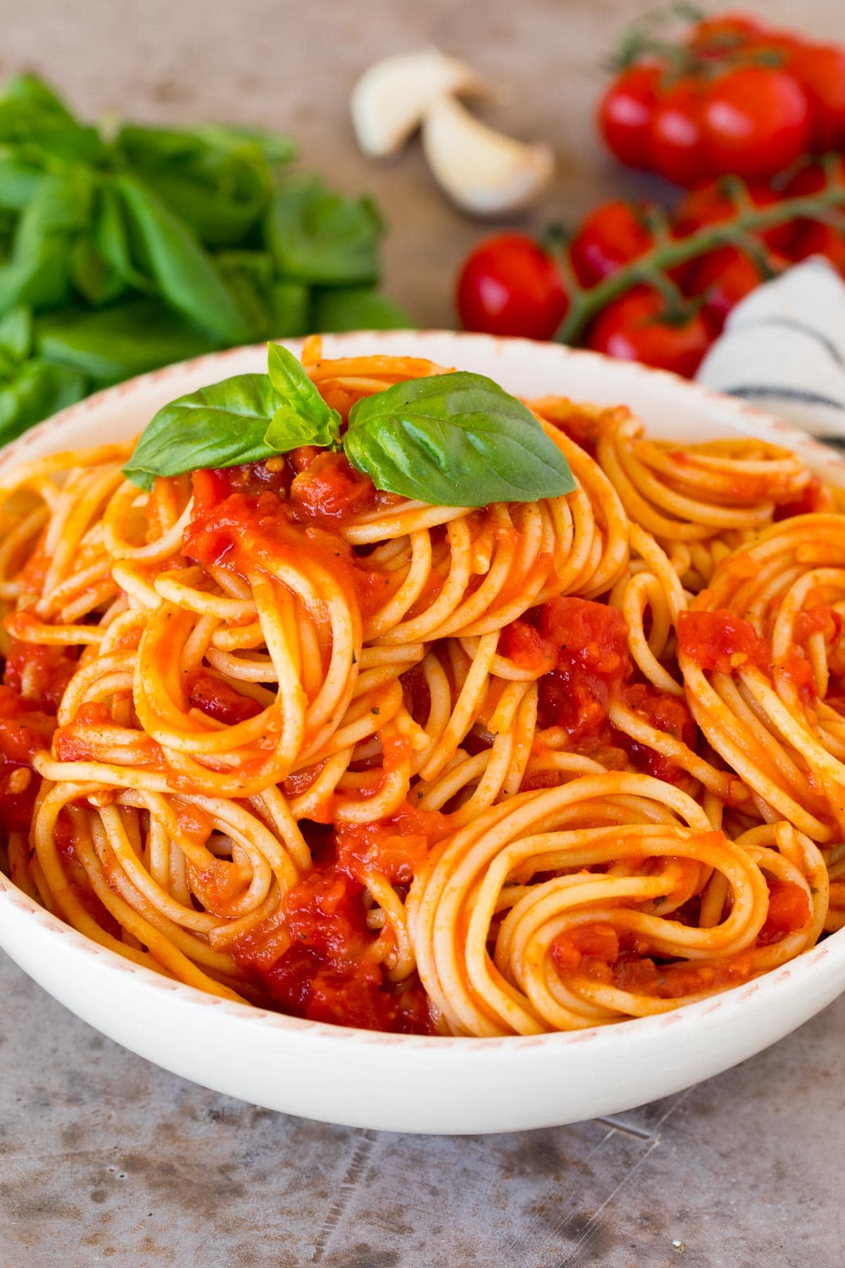 Spaghetti tossed with marinara sauce in a bowl.