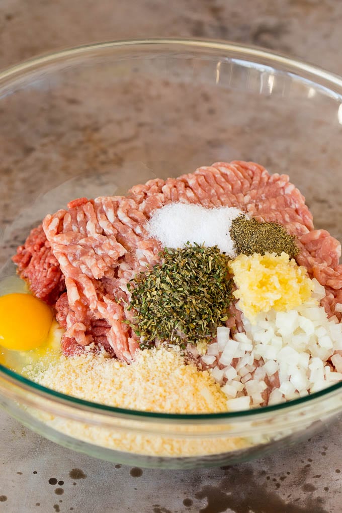 Ground beef, pork and seasonings in a mixing bowl.