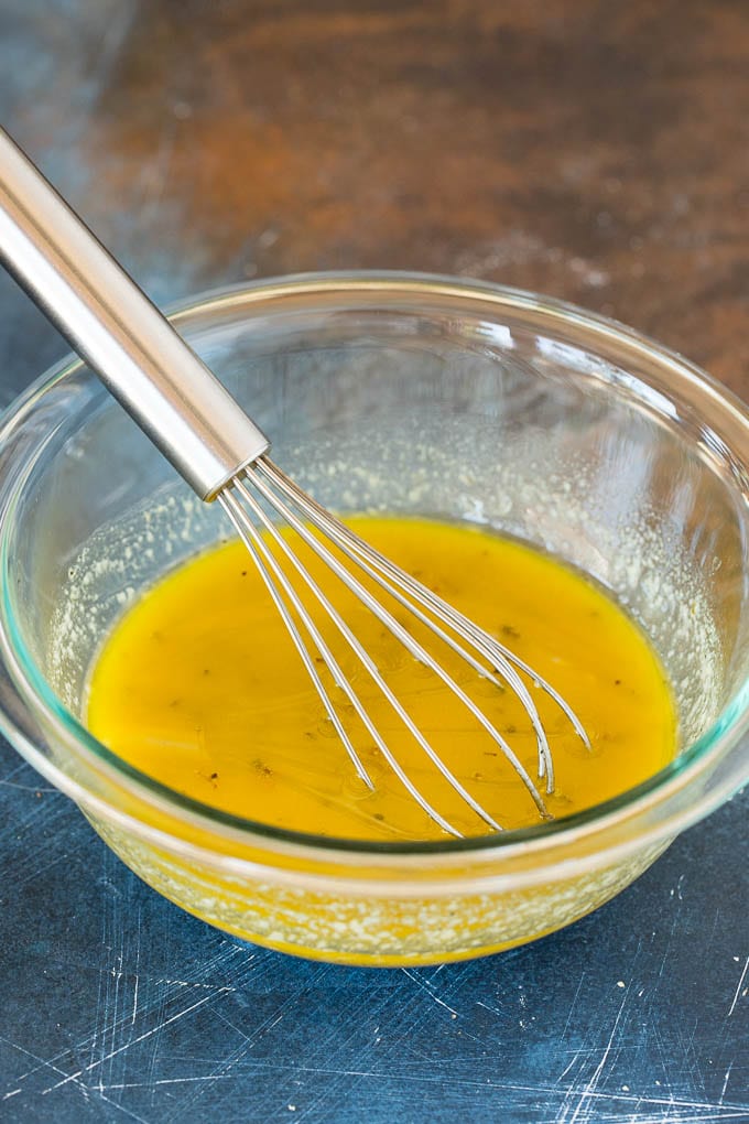 A glass bowl of homemade salad dressing.