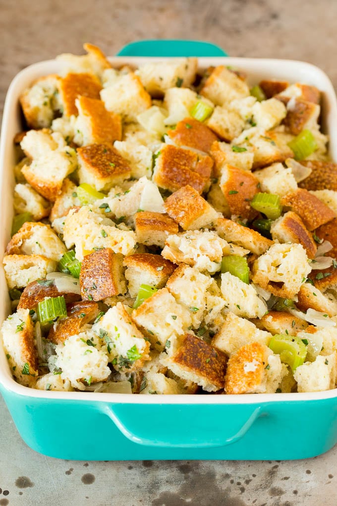 This Thanksgiving stuffing is a mixture of bread cubes, vegetables and plenty of herbs, all baked together until golden brown. Uncooked stuffing in a baking dish.