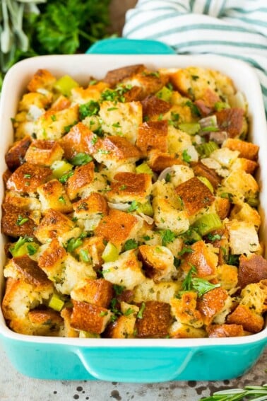 Thanksgiving stuffing in a baking dish, topped with parsley.