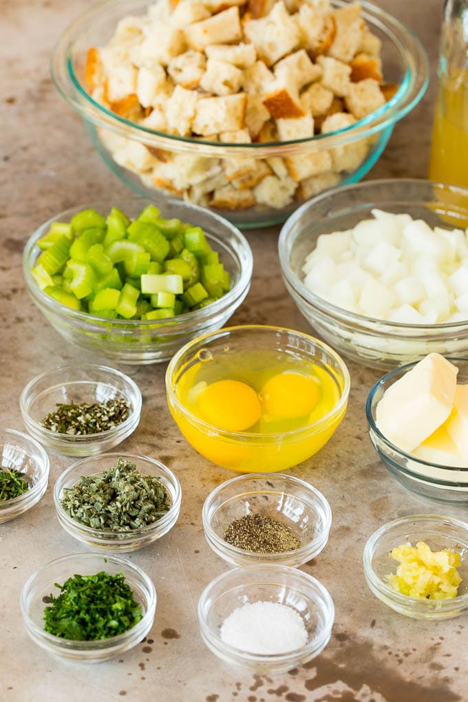 Bowls of ingredients including bread cubes, vegetables and herbs.