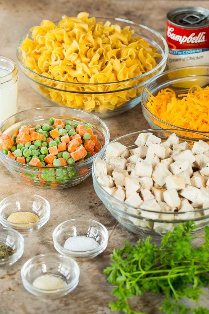 Bowls of poultry meat, vegetables, noodles and seasonings.