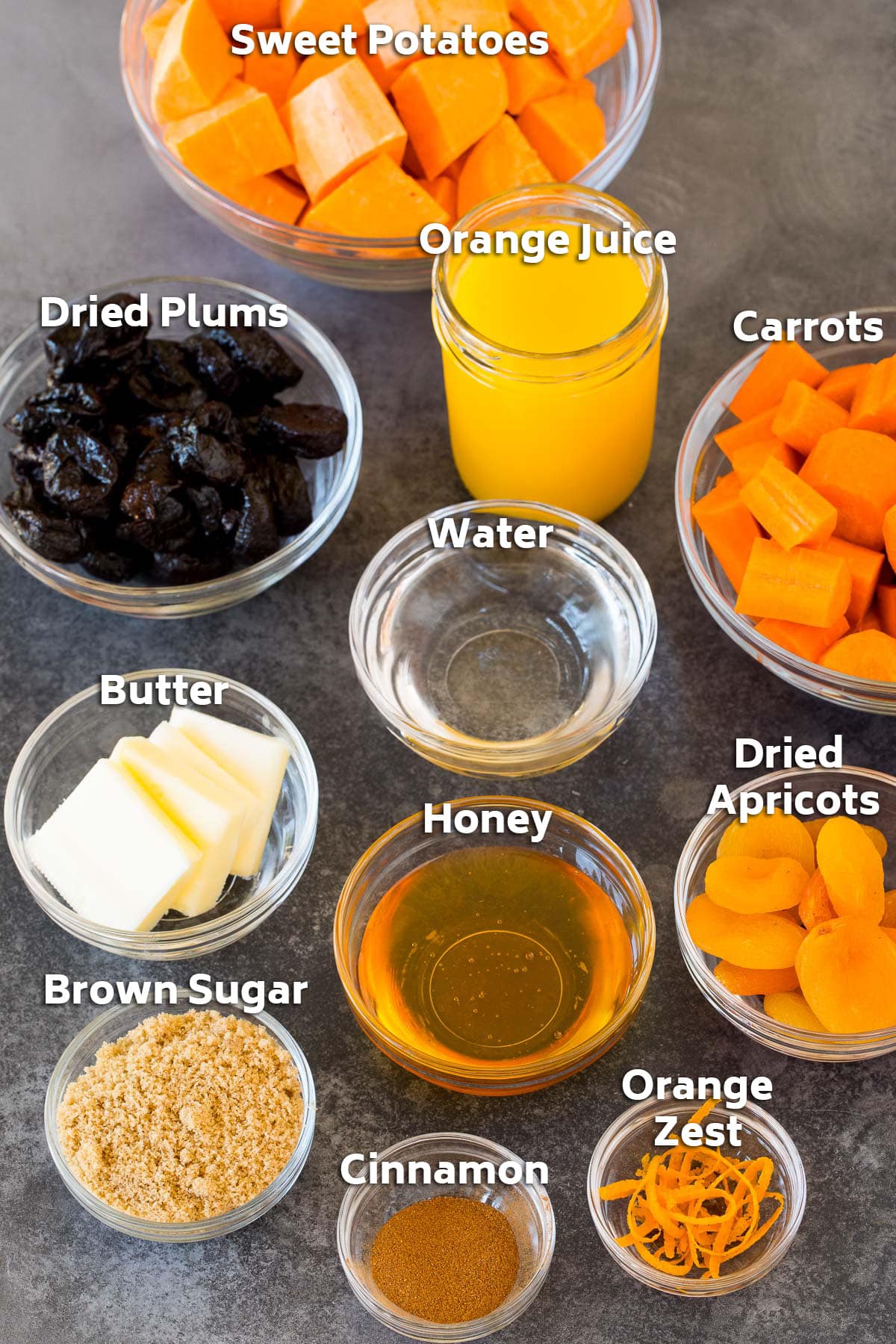 Bowls of ingredients including vegetables, dried fruit, sweeteners and seasonings.