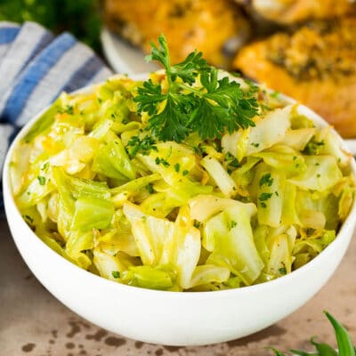 A bowl of sauteed cabbage topped with parsley.