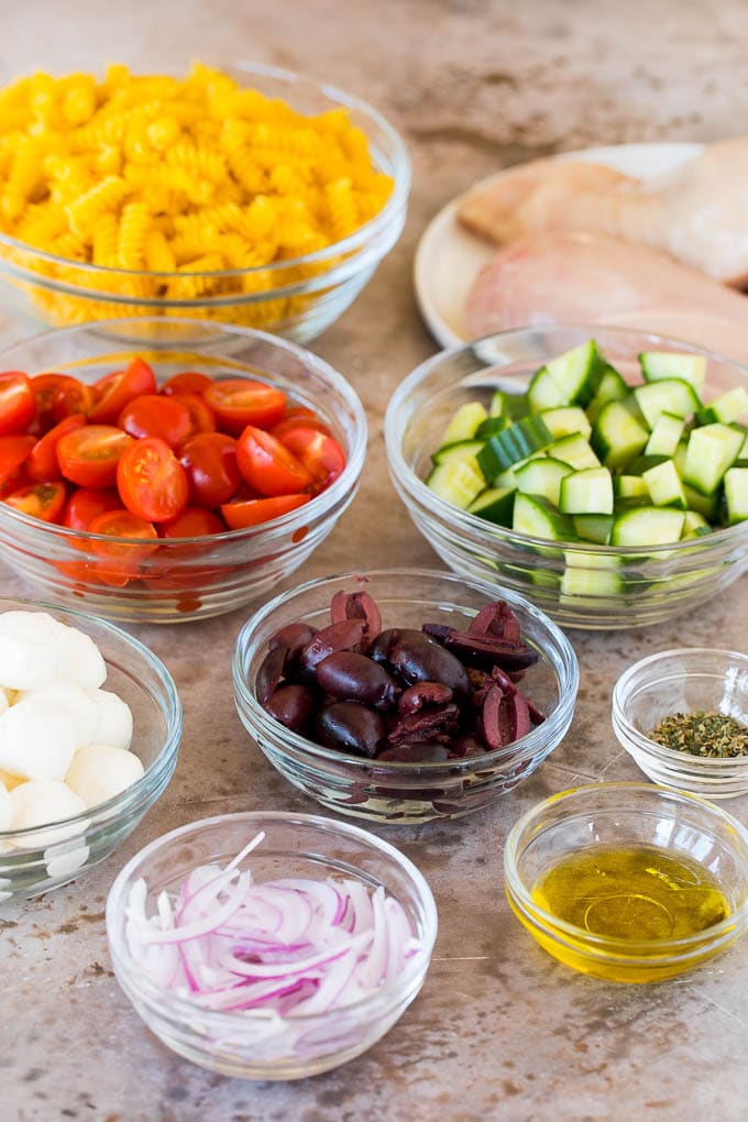 Bowls of vegetables and dry pasta.