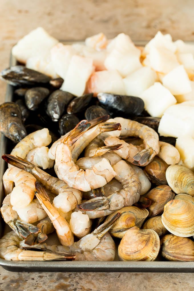 A pan of shrimp, clams, fish and mussels.