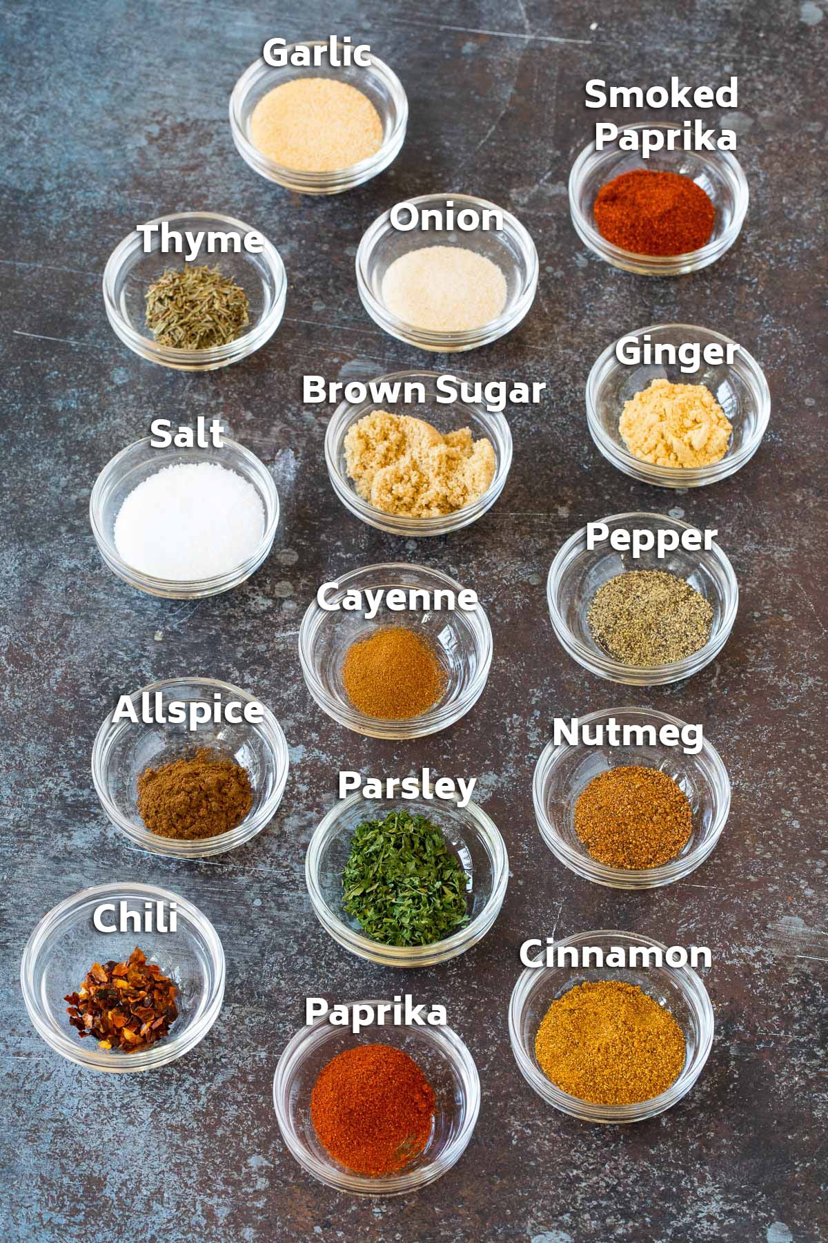 Small glass bowls of herbs and spices.