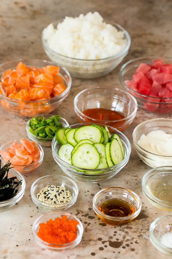 Bowls of diced fish, cucumbers, rice and seasonings.