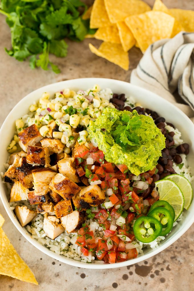 A burrito bowl with chicken, rice, salsa, beans and Chipotle guacamole.