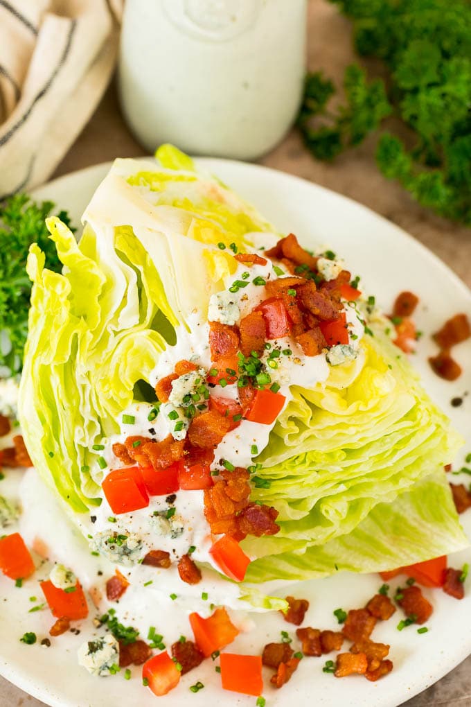 Blue cheese dressing on top of a wedge salad.