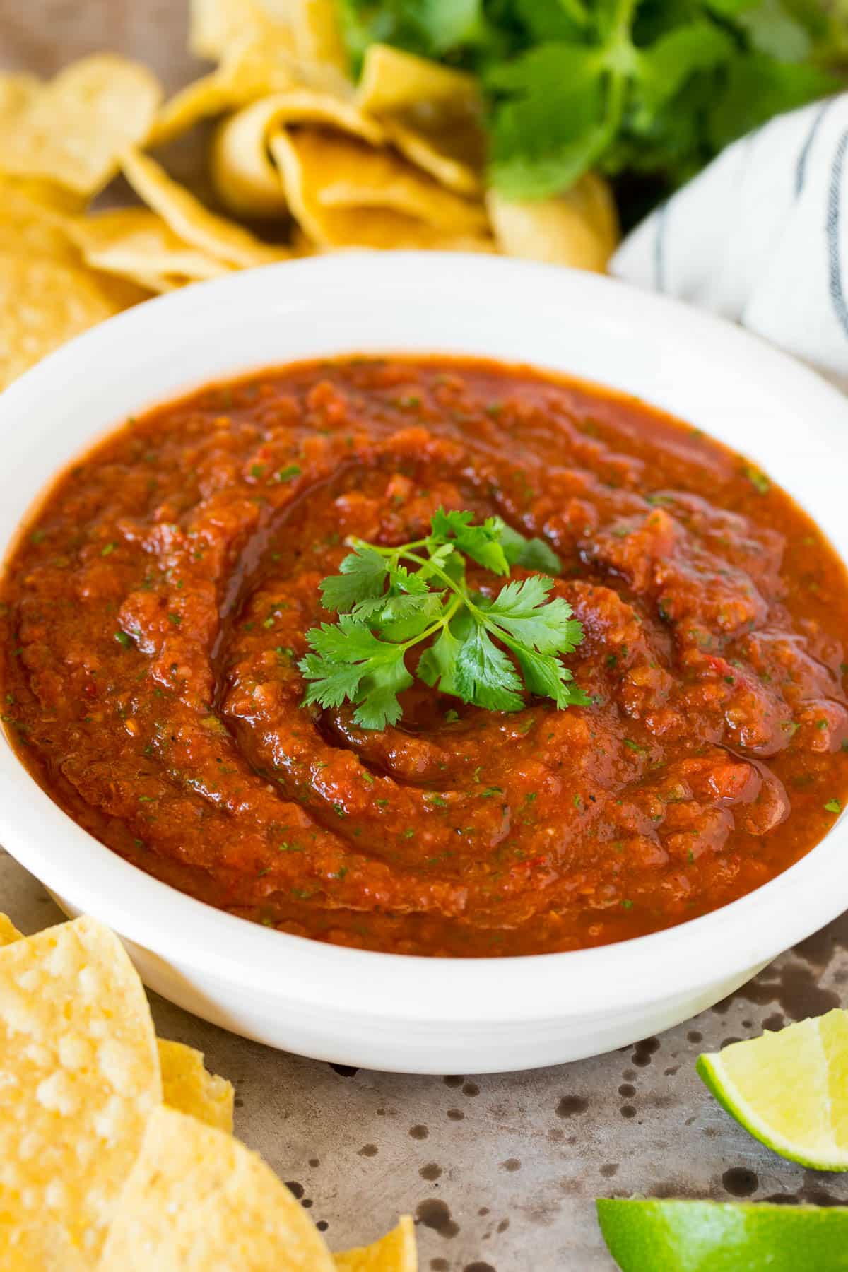 A bowl of chipotle salsa garnished with fresh cilantro.