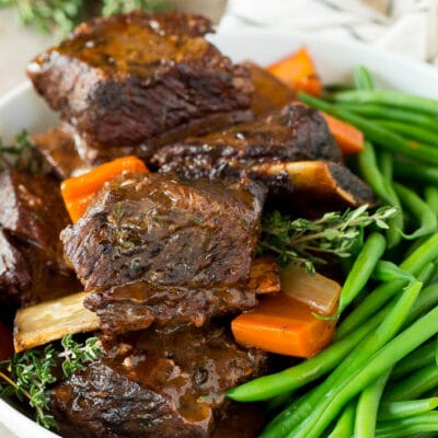 A serving bowl of slow cooker short ribs and green beans.