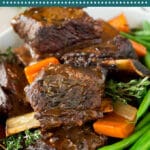 These slow cooker short ribs are cooked in the crock pot with red wine, herbs and vegetables until tender.