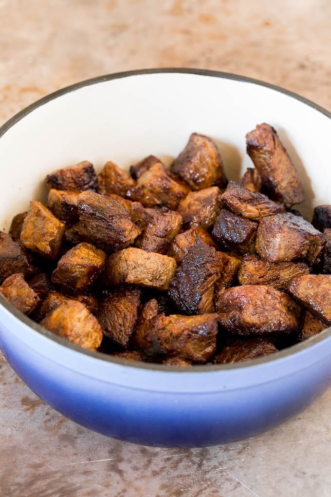 Seared beef chunks in a pot.