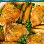 This chicken Vesuvio is tender chicken thighs and potato wedges that are roasted until golden brown, then served with peas and a white wine sauce.