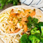 A plate of shrimp linguine served with broccoli.