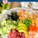 This sushi bowl recipe is assorted fresh fish, avocado, cucumber and seaweed, all served over rice with spicy mayo, picked ginger and tobiko.