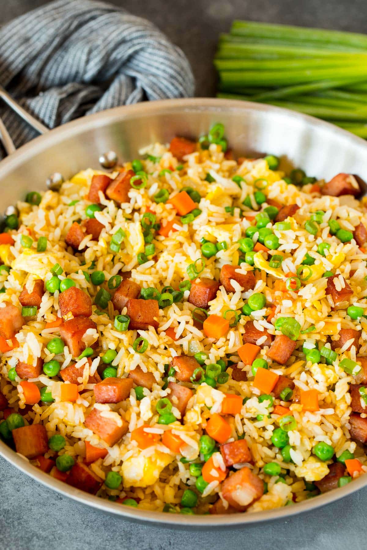 A pan of fried rice with meat and vegetables.