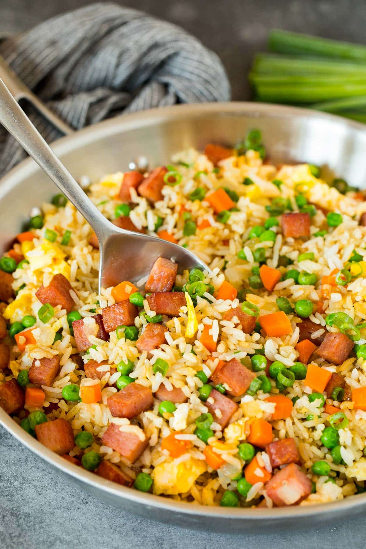 A serving spoon in a pan of Spam fried rice.