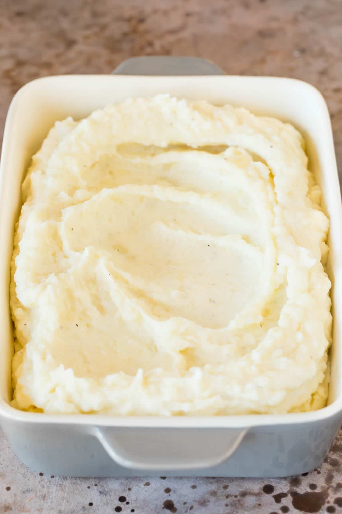 Mashed up potatoes in a baking dish.