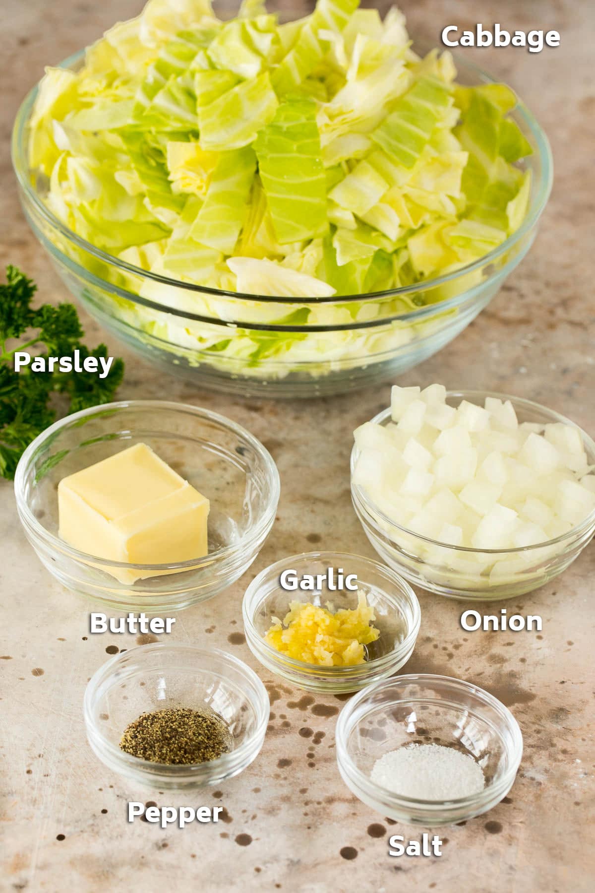 Bowls of cabbage, onion, butter and seasonings.