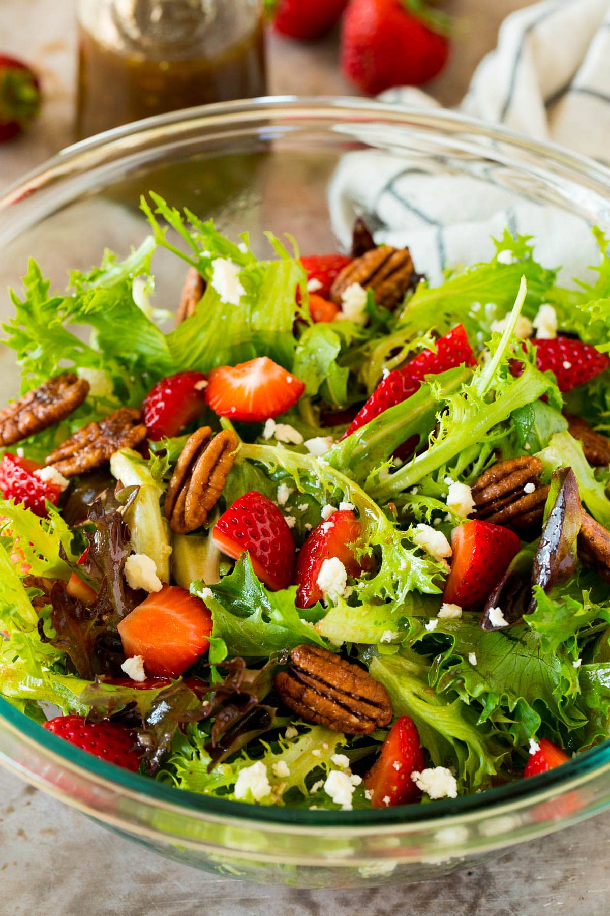 A salad made with balsamic vinaigrette and strawberries.