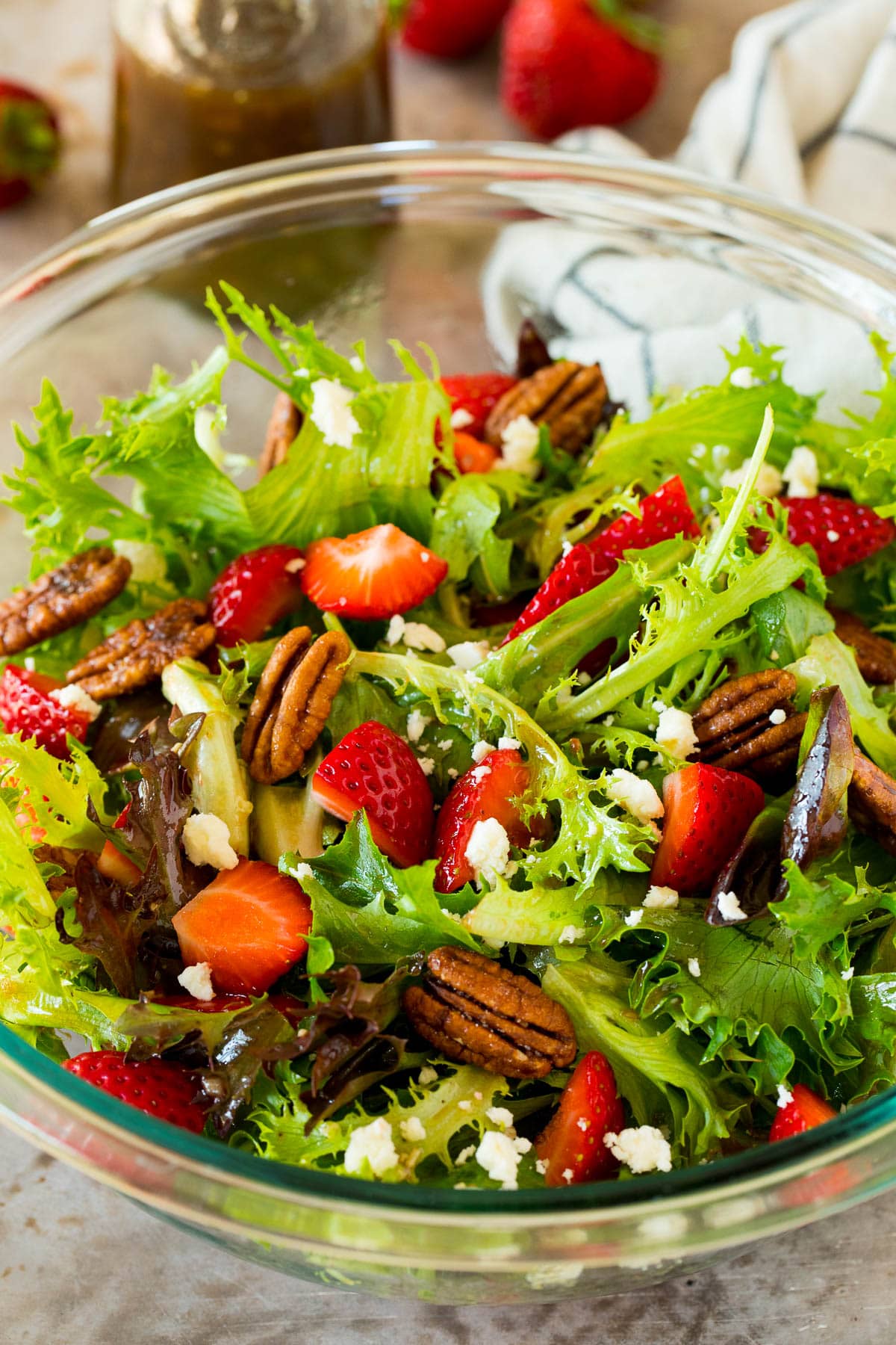 This balsamic vinaigrette is a flavorful dressing that adds bold flavor to salads, vegetables and even proteins. A salad made with balsamic vinaigrette and strawberries.