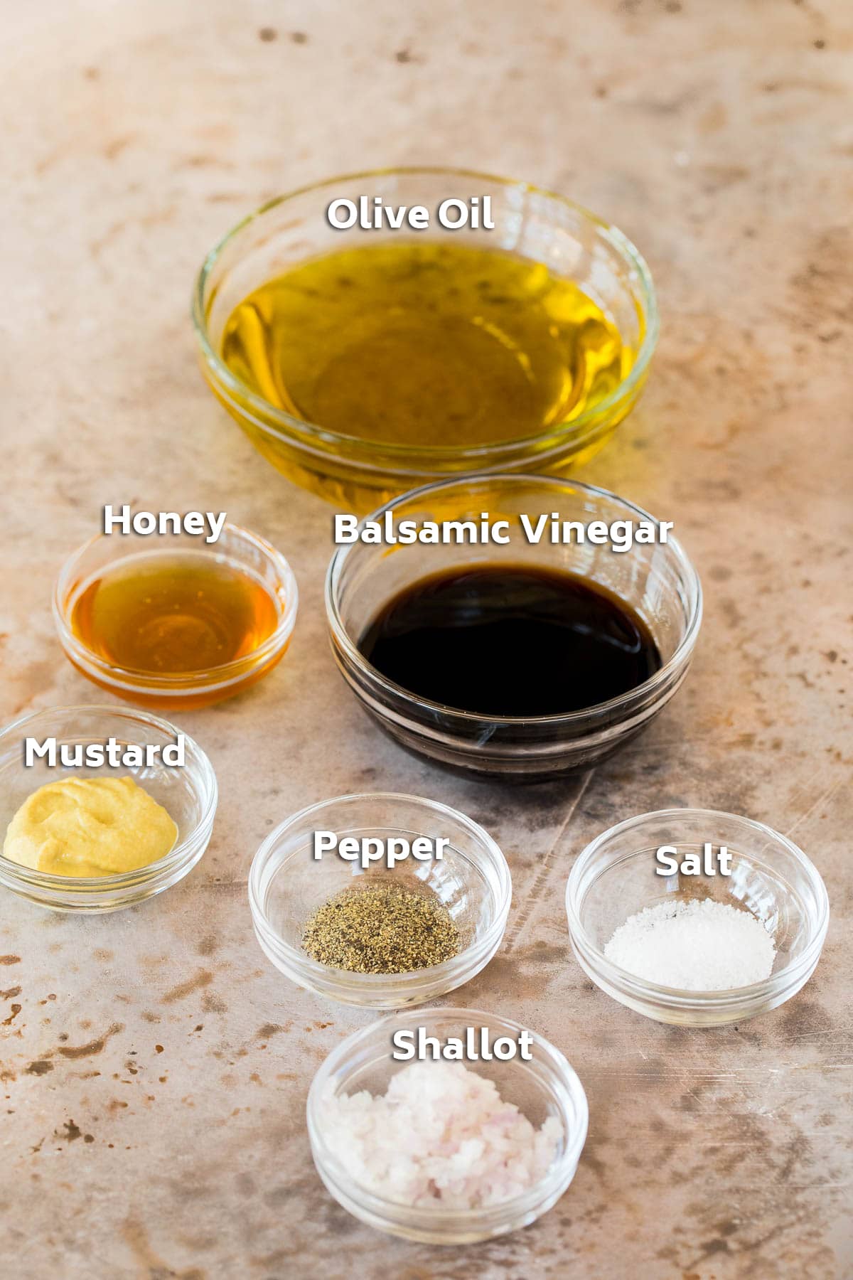 Bowls of ingredients including oil, vinegar and seasonings.