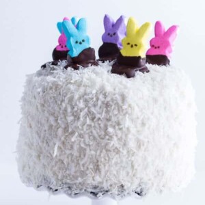 An image of a coconut cake with peeps on top.
