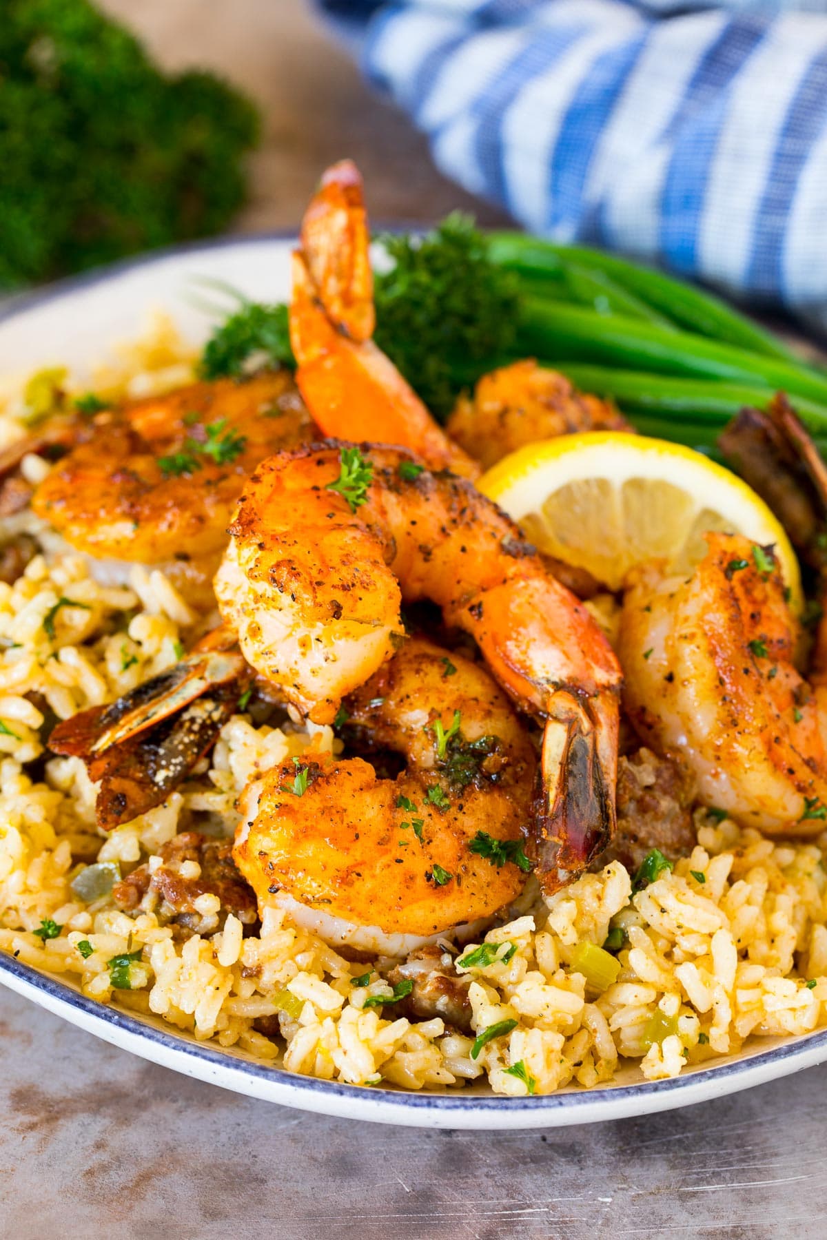Cajun shrimp served over a plate of dirty rice.