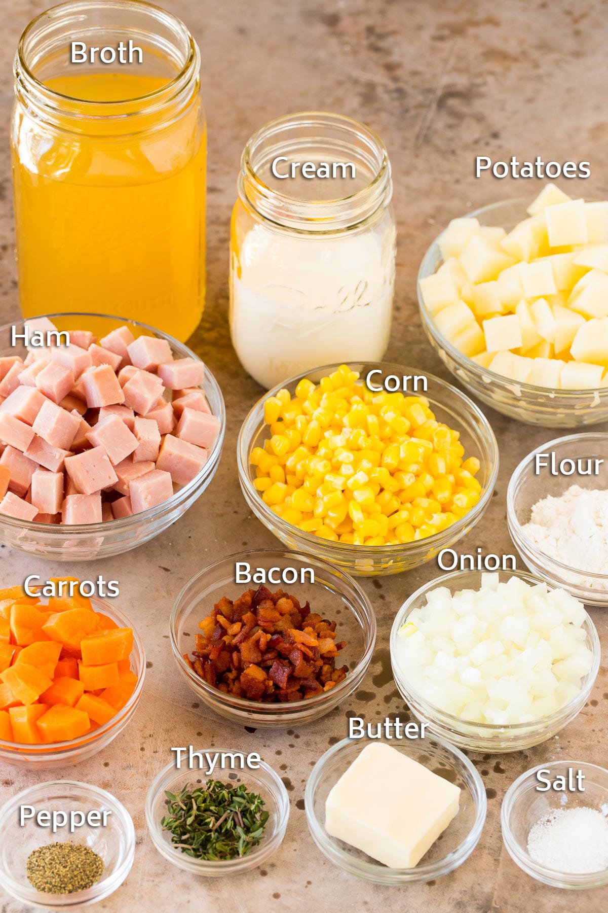 Bowls of ingredients including ham, seasonings, vegetables and potatoes.