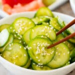 Chopsticks serving a portion of Japanese cucumber salad.