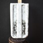 A picture of a cookies and coconut cream popsicle.