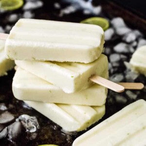A picture of some key lime flavored popsicles on ice.