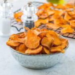 An image of a bowl of baked sweet potato chips.