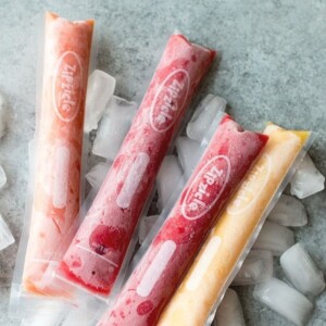 A picture of 4 homemade ice pops in different flavors.