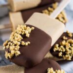 An image of peanut butter popsicles dipped in chocolate.