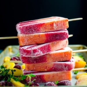 An image of a stack of peach and raspberry melba popsicles.