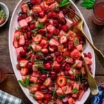 An image of a large oval bowl with cherries, strawberries and watermelon.
